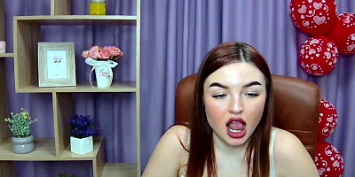 Busty redhead strips bra closeup