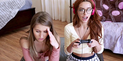 Two horny teens play with each others clits while gaming