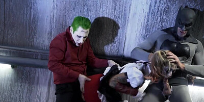 A sexy bimbo is getting fucked by two men in a batman parody scene