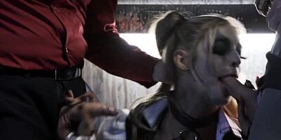 A sexy bimbo is getting fucked by two men in a batman parody scene