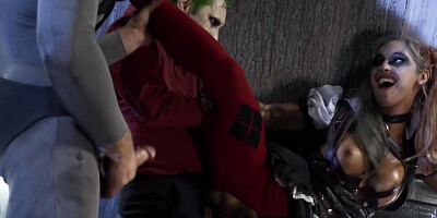 A sexy bimbo is getting fucked by two men in a batman parody scene