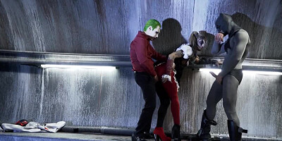 A sexy bimbo is getting fucked by two men in a batman parody scene