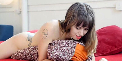 Busty babe with a couple of tattoos is masturbating