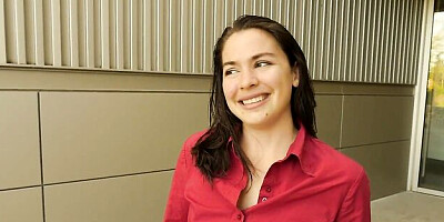 Smiling happy brunette Lilith Wilder is playing with her shaved pussy