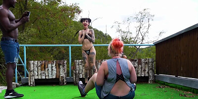 Two horny ladies are doing a fetish photoshoot outdoors