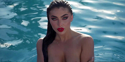 Glamorous naked babe posing by the pool