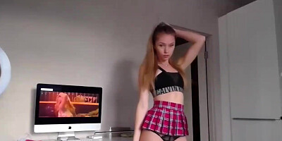 Excited light-haired nubile with ponytails is dressed in a mini micro-skirt while playing her vagina on web cam