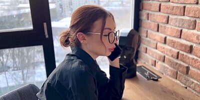 Hot slut talking on the phone with her husband while her friend fucks her.