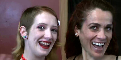 Redhead and brunette have their mouths filled with dicks