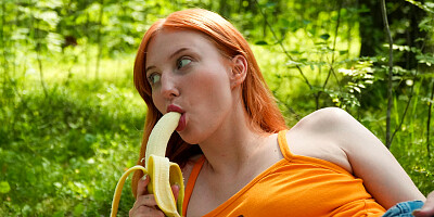 Redhead Emma Korti plays by herself in outdoor scenes until she comes