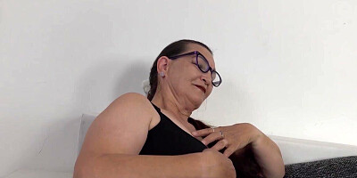 The two mature women are masturbating on the couch