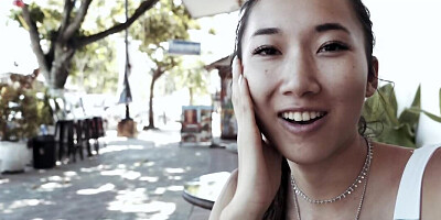 Asian cutie is blowing a complete stranger at the beach