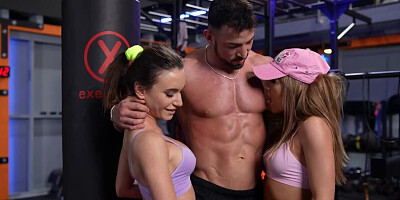 Gym threesome with a hunky lad and a duo of horny babes