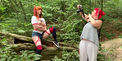 Ginger lady is posing for a photo session in the woods