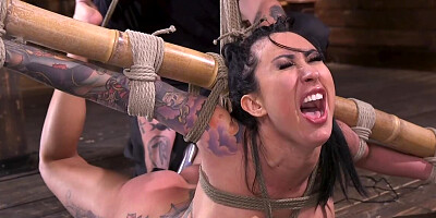 Inked chick is stripped naked and tied in some strict shibari