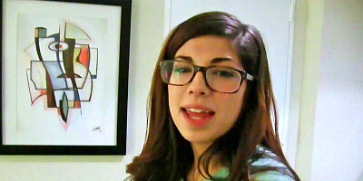 Ava Taylor wears her glasses while she plays with a cock