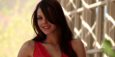 A solo girl is doing a hot striptease before the camera lens