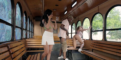 Two hot girls and a guy are having threesome in the bus