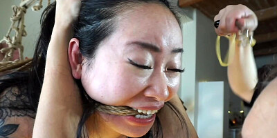 Asian girl is bound in tight ropes and tortured by two girls