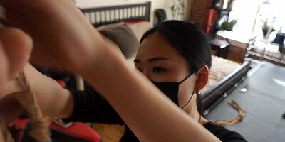 Asian girl is bound in tight ropes and tortured by two girls