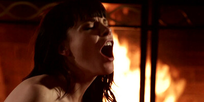 A brunette gets her pussy fucked by the warm fire indoors