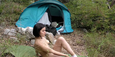 She sets up the tent and starts masturbating her hole