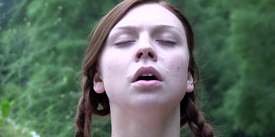 Busty babe in pigtails toys her wet pussy by the creek