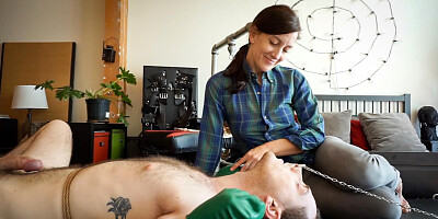 German woman and a submissive man making a BDSM tape