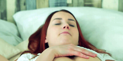 A slutty redhead rubbing herself in a solo XXX video