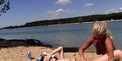 Brunette gets tits sucked and pussy eaten by blonde on a beach