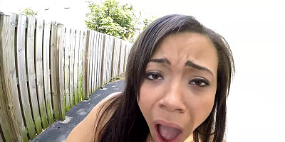 A skinny ebony girl is getting naked outside next to a bike
