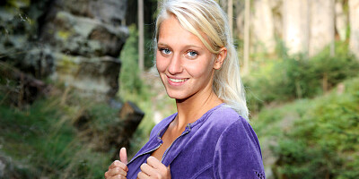 Blonde Teases Her Pussy on a Mossy Cliffside Trail