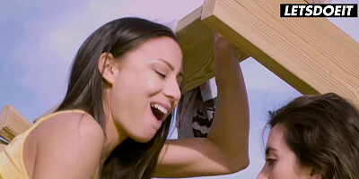 Two women share a man on the beach