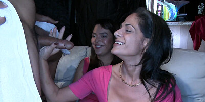 A gorgeous redhead is sucking cock in front of her friends