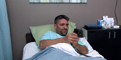 A curly nurse is helping her patient get well in the hospital