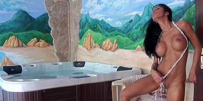 A solo girl is next to a hot tub, getting her pussy caressed