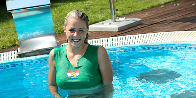 Small titted blonde spreads and fingers pussy poolside
