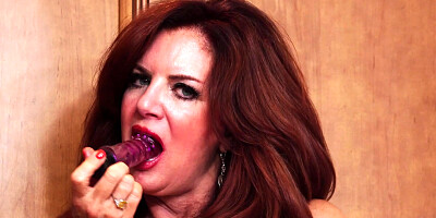 Redhead housewife Andi James plays with her favorite sex toy in the kitchen