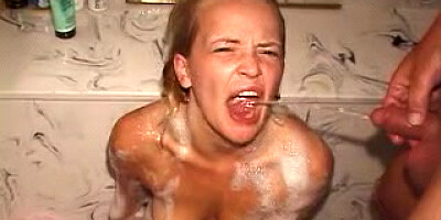 Girl on knees getting piss