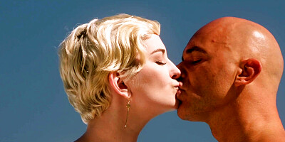 Short-haired bombshell Skye Blue pleasures her bald-headed lover by the water