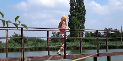 Voyeur camera catches a blonde peeing off a bridge