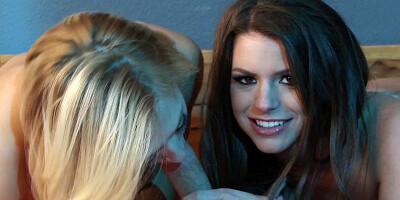 A blonde and brunette busty friends are fucking on the bed