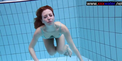 Hot Redhead teasing in the Pool