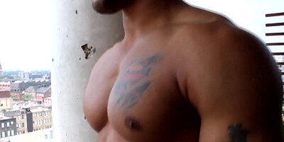 Buff black muscle guy masturbates on balcony