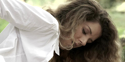 A sexy brunette with curly hair is massaging her wet pussy lips