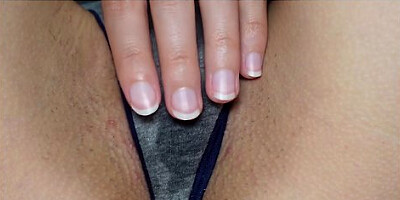 Wet panties betray her arousal as she touches herself