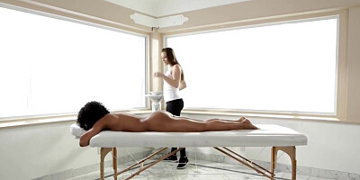 Black woman is getting a massage as foreplay for fingering