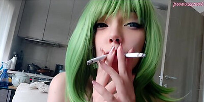 Green-haired girl smokes two cigarettes at once