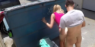 A blonde is pressed against the dumpster and she is fucked well
