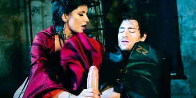 A girl with sizable tits is sucking a hard large dick in the dungeon